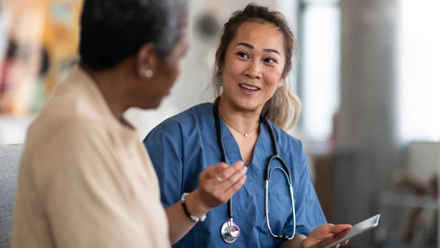 A care professional advises a patient.