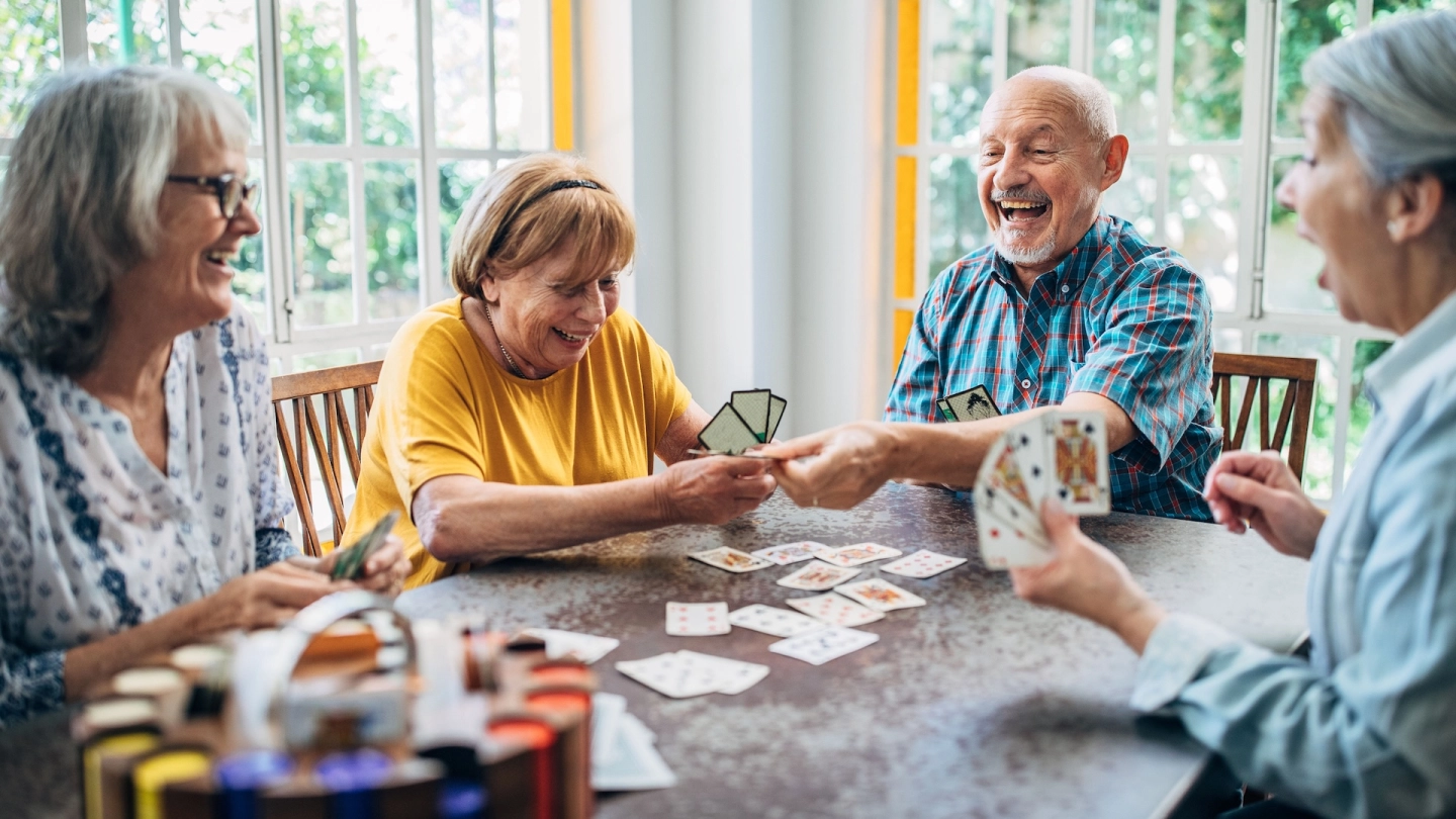 Mental health in later life: older woman looking straight ahead, lost in thought. She is supporting her head on one hand and holding a handkerchief to her face with the other. She looks sad.